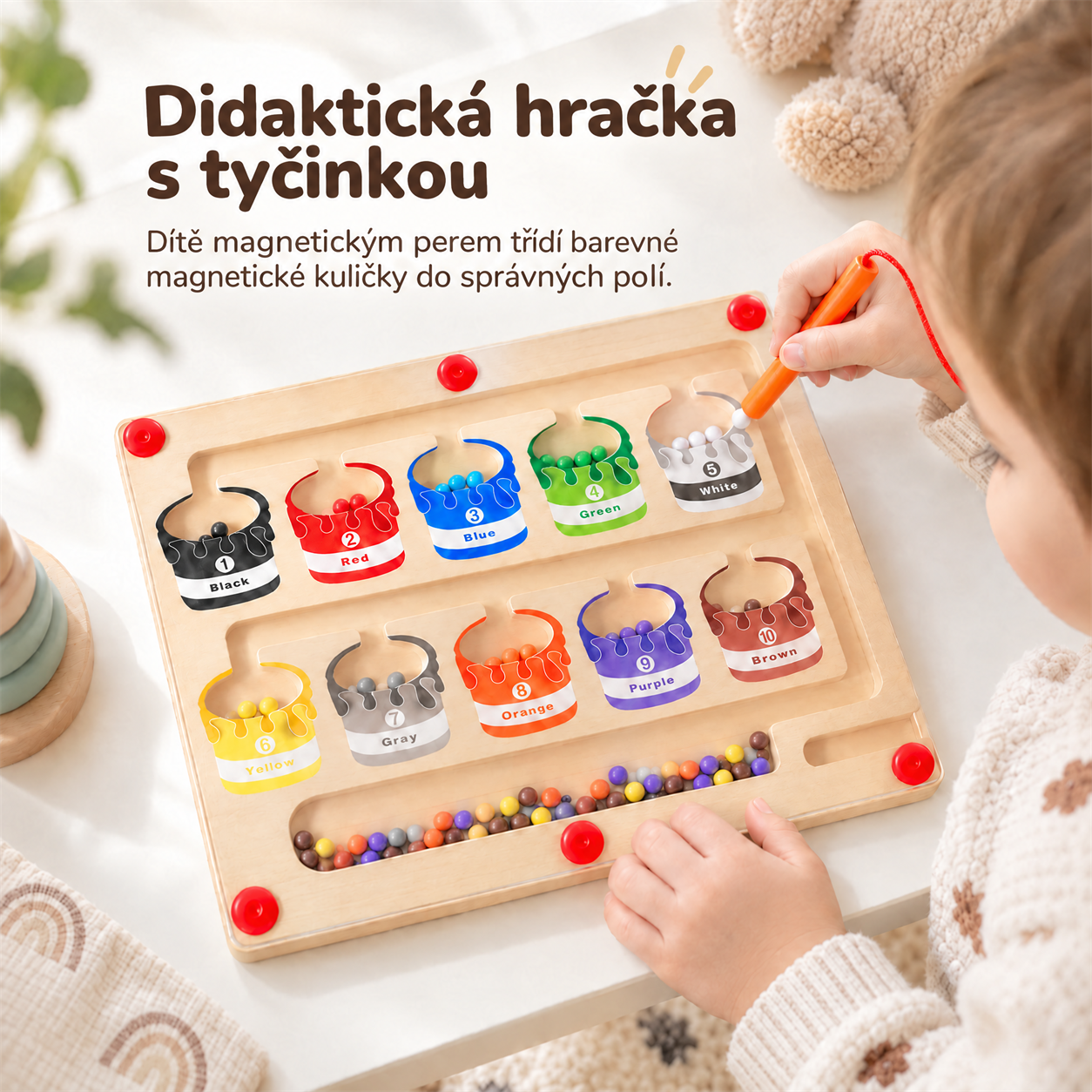 Didaktična igrača ima paličico, s pomočjo katere otrok razvršča barvne magnetne kroglice v pravilna polja!
